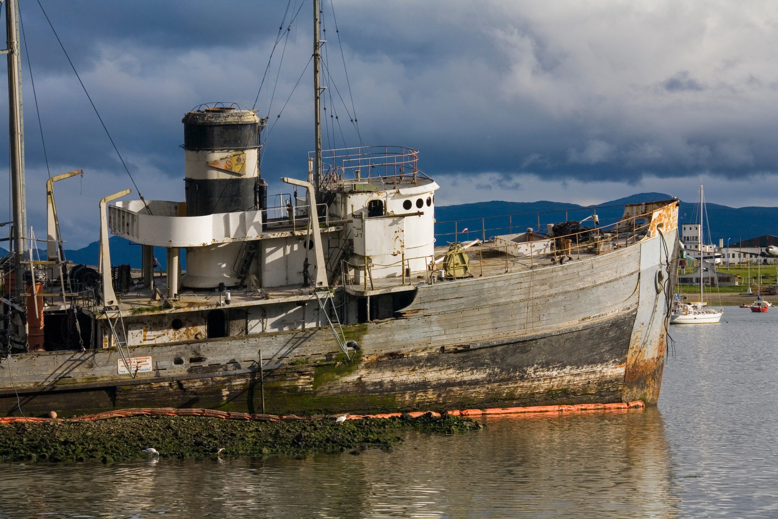 Wreck of a fishing boat in the harbor at Ushuaia on Tierra Del Fuego in southern Argentina, South America.